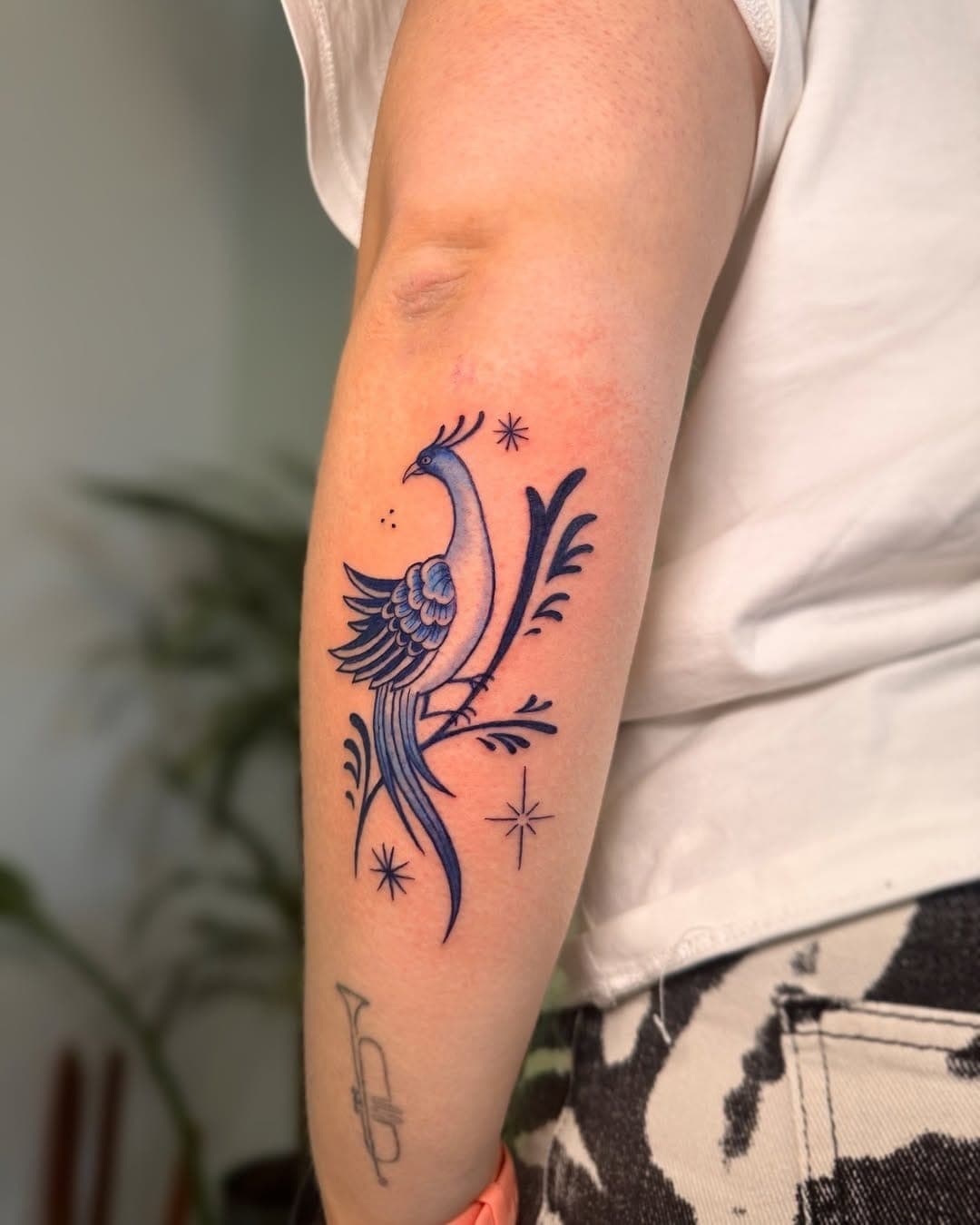 Delft Blue tattoo, ornamental bird forearm