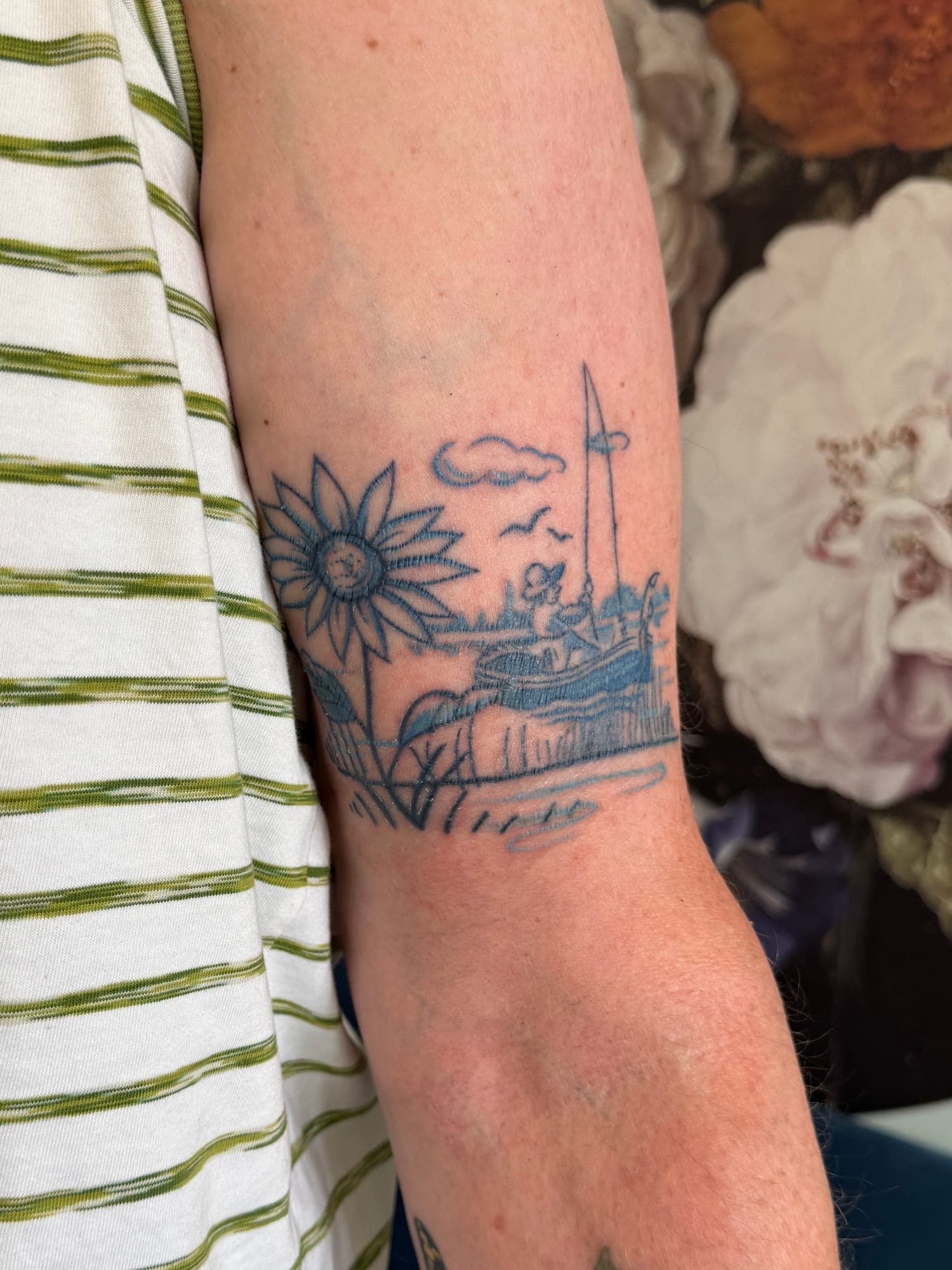 Healed Delft Blue tattoo, dutch landscape floral arm