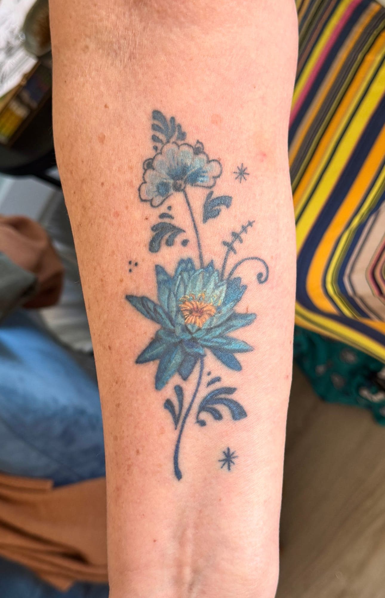 Healed Delft Blue tattoo, floral forearm