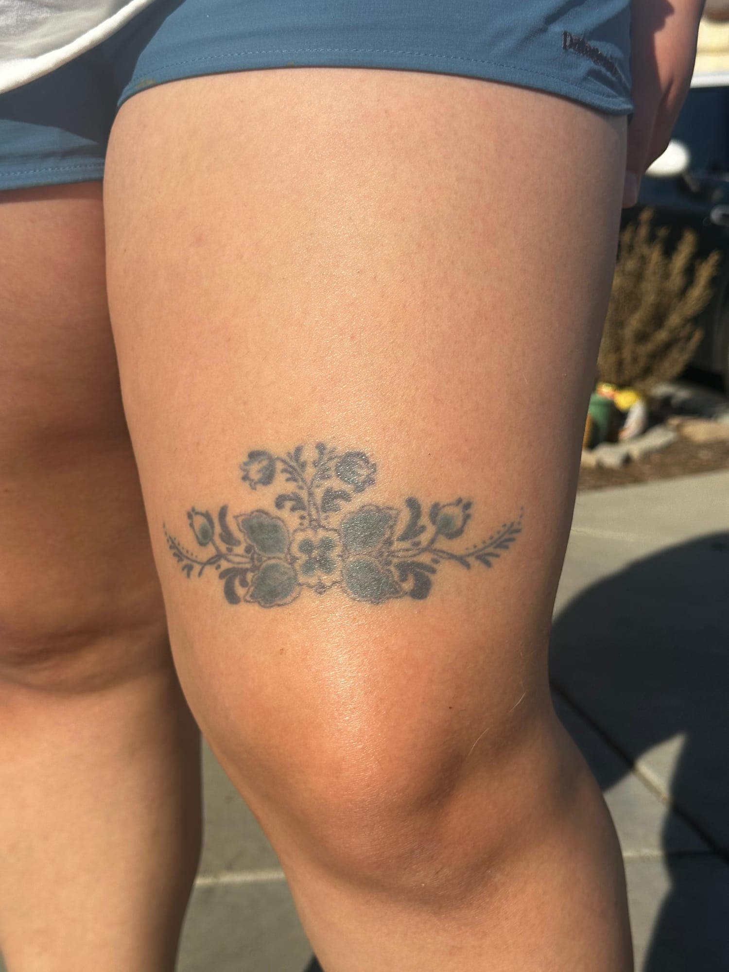 Healed Delft Blue tattoo, floral thigh