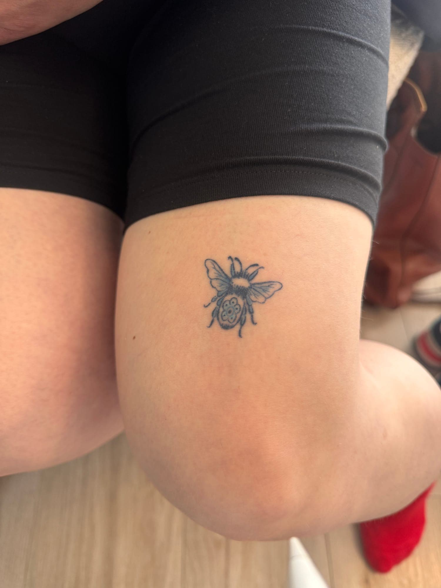 Healed Delft Blue tattoo, small flower elbow