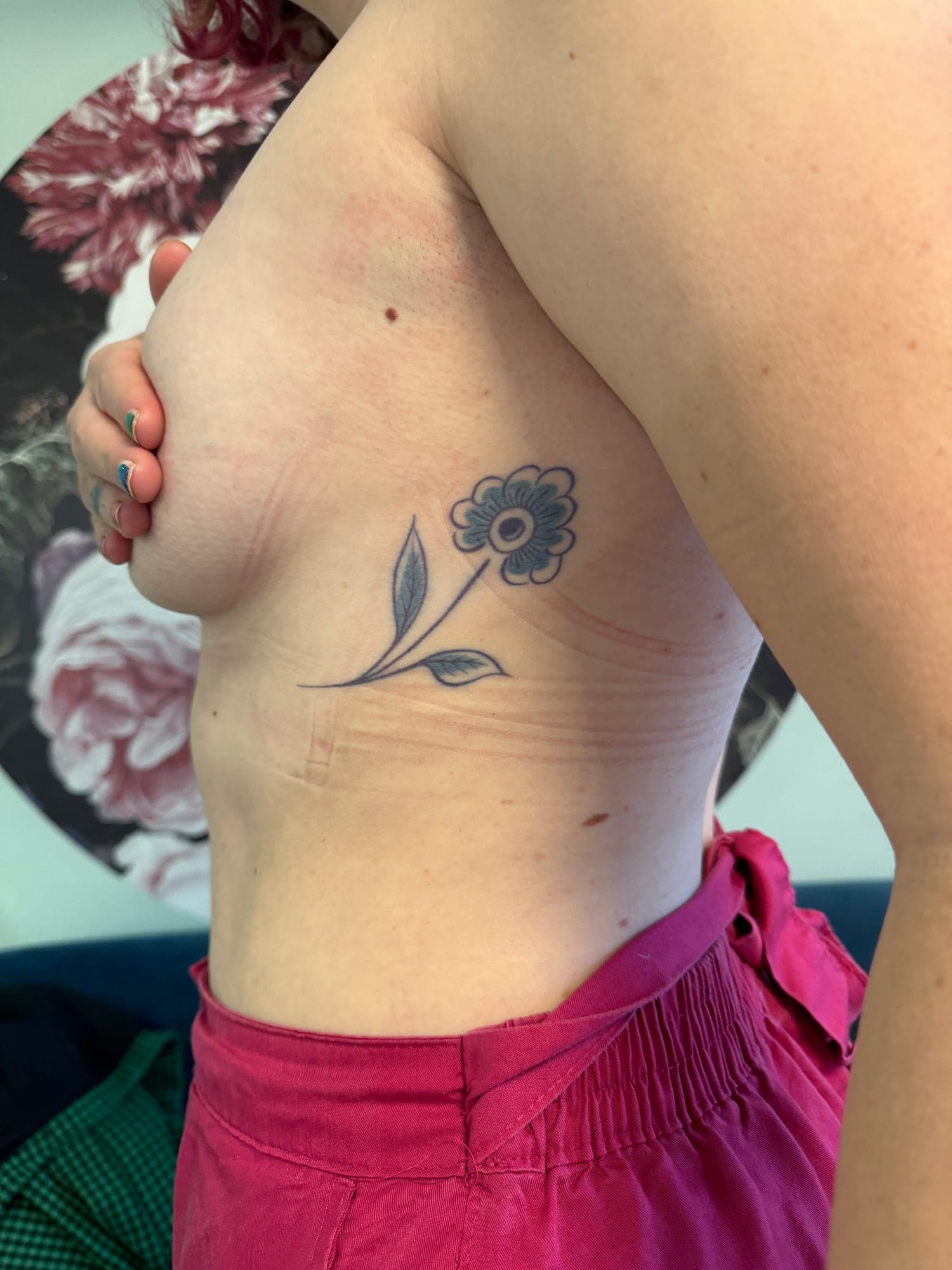 Healed Delft Blue tattoo, small flower rib