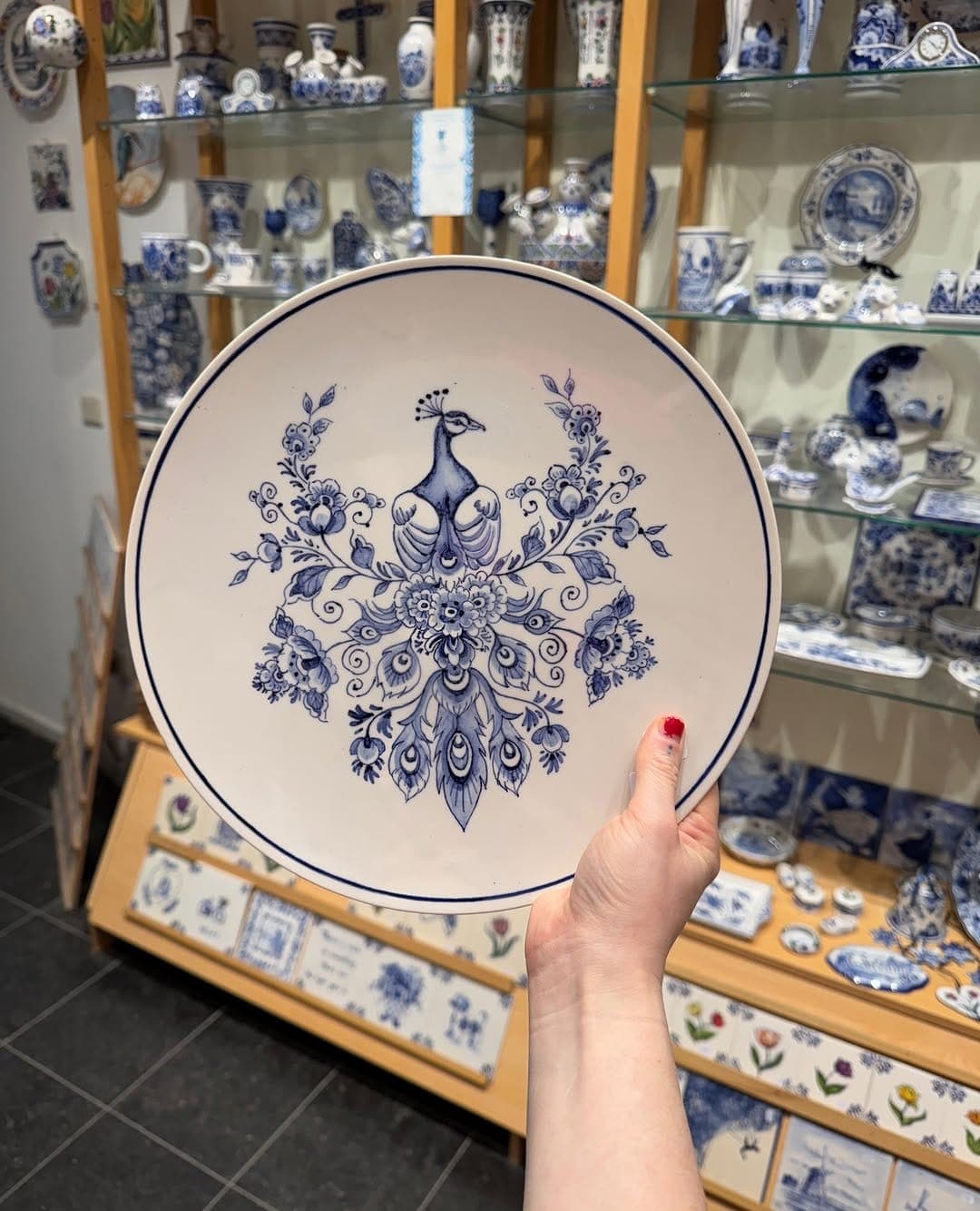 Delft Blue plate with a painted peacock